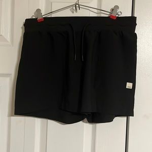 Black Vuori athletic shorts.